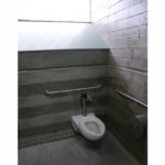 A typical toilet stall. The small holes at the base of the wall bring in fresh air from tubes located 3' below the boardwalk, where the temperature is a constant 55 degrees. The air is exhausted out the top of the solar chimneys, a pleasant 30’' above the pedestrians on the boardwalk.