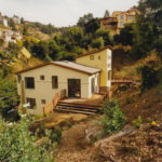 The home is nestled on a steep slope