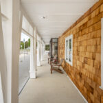 Front porch.  Columns are solid timber, siding is wood shingles.